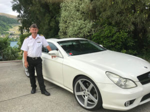 Wayne Perkins, owner of QUeenstown Lake Cruise with their vehicles